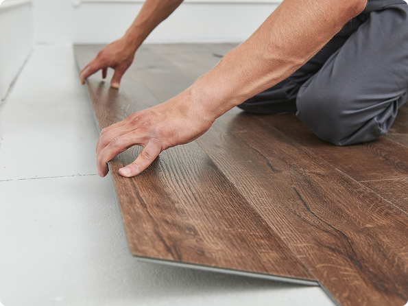 Close-up of luxury vinyl plank flooring wear layer showing durability tier for high-traffic areas and pets